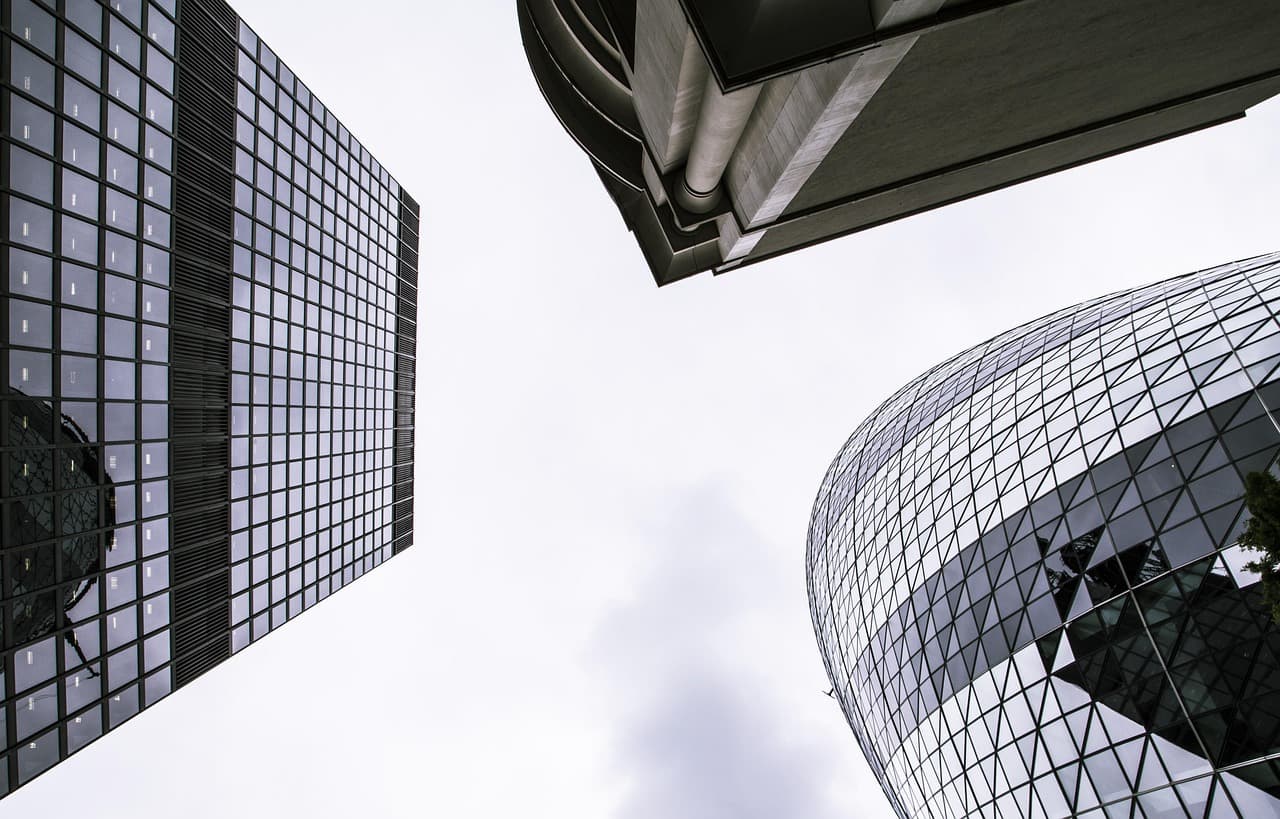 Glass office towers seen from street level, illustrating the Caribou auto refinance report on Q3 2026 car loan savings
