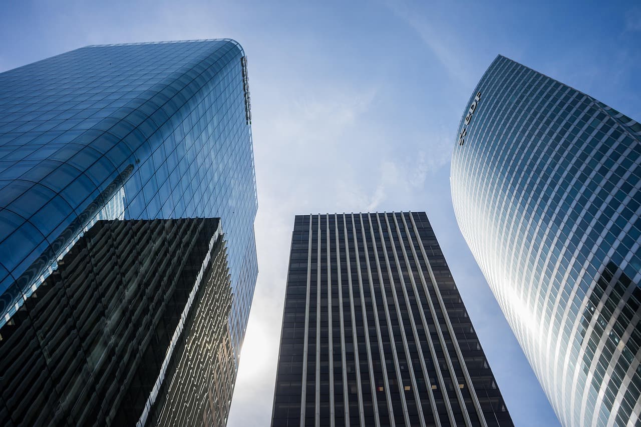 Glass office towers, illustrating the Coinbase RLUSD stablecoin listing
