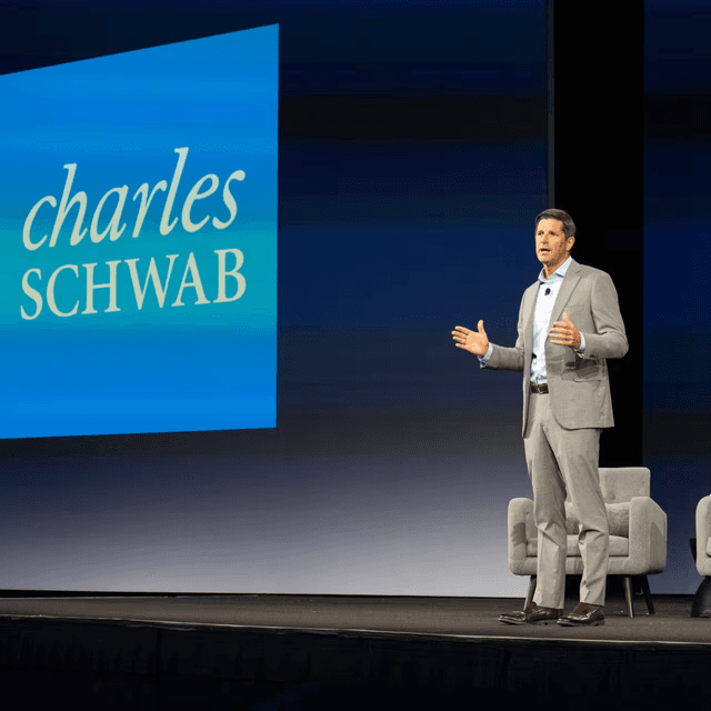Historic stock exchange building with a tall spire, illustrating Schwab Charley and the brokerage's AI assistant