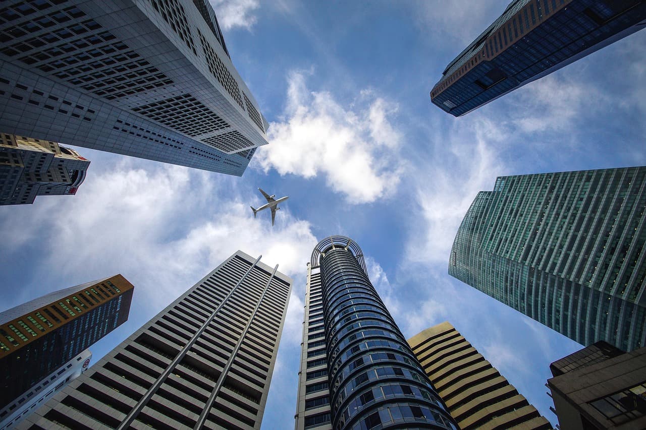 Office towers seen from street level, illustrating LemFi's expansion into savings and credit