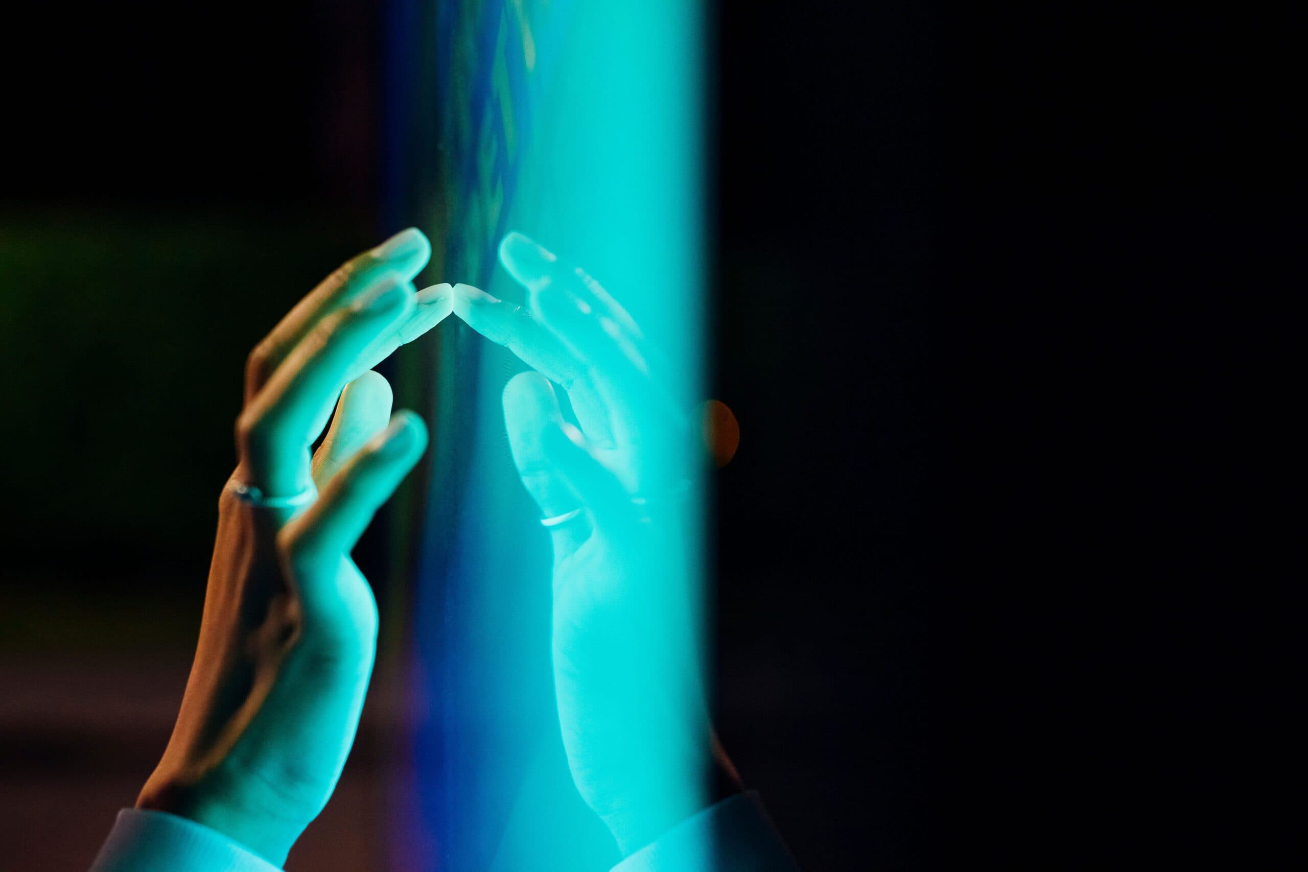 Ey woman touching kiosk screen at night v2.jpg