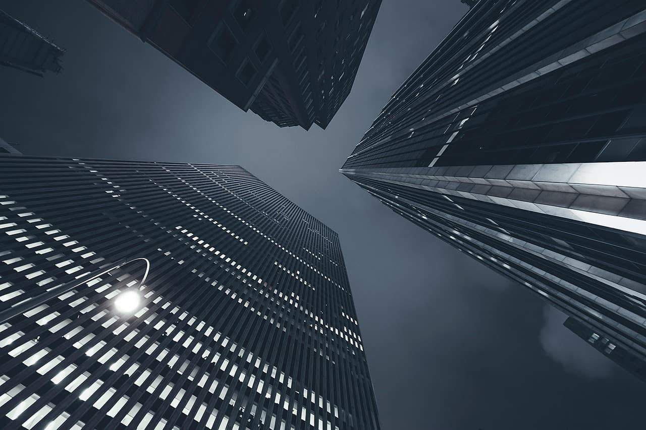 New York office towers in fog, illustrating C2FO Instant Pay on the XRP Ledger