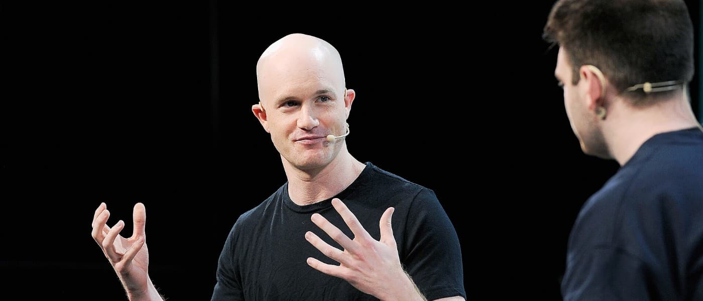 Coinbase chief executive Brian Armstrong speaking on stage, illustrating Coinbase Q3 2026 results